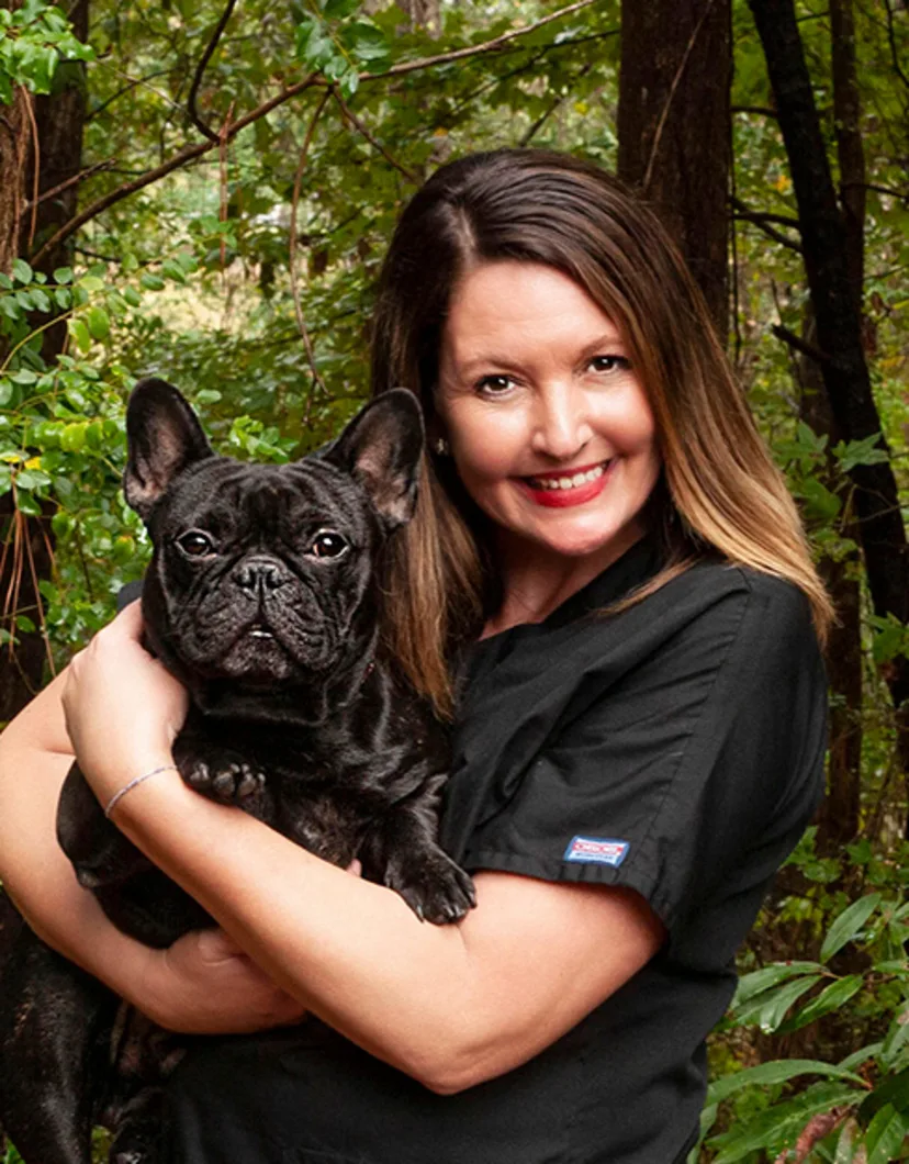 Crystal Thielepape Holding a Black Dog